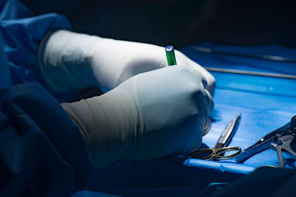 Surgeon preparing for combined hernia repair